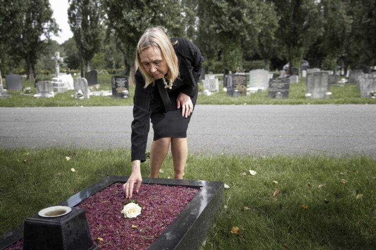 Elderly Woman Visiting Grave Loved One